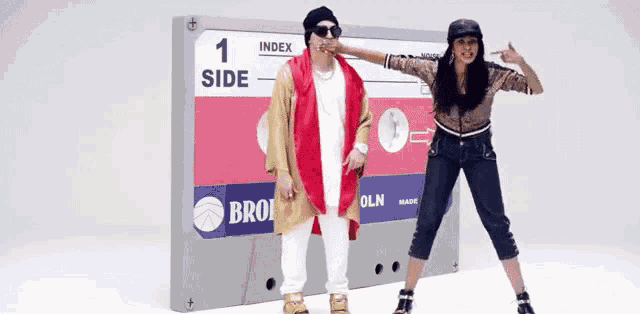 a man and a woman are dancing in front of a cassette tape that says index side 1