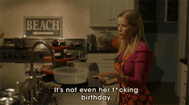 a woman in a kitchen with a sign that says beach