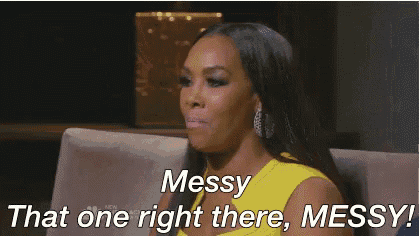 a woman in a yellow dress is sitting on a couch and says messy that one right there messy .