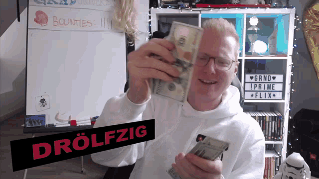 a man holding a bunch of money with a sign that says drolfzig