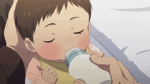 a baby is drinking milk from a bottle with a person holding it