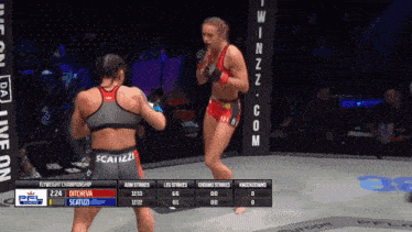 two women are fighting in a cage and one of them is wearing a scarizzz top