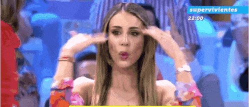 a woman is making a funny face in front of a screen that says supervivientes .
