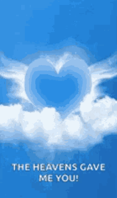 a blue heart shaped cloud in the sky with the words `` the heavens gave me you '' written below it .