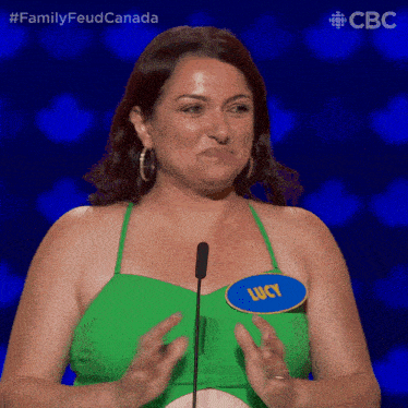 a woman with a name tag that says lucy stands in front of a microphone