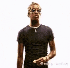 a man in a black shirt and blue jeans is standing in the air
