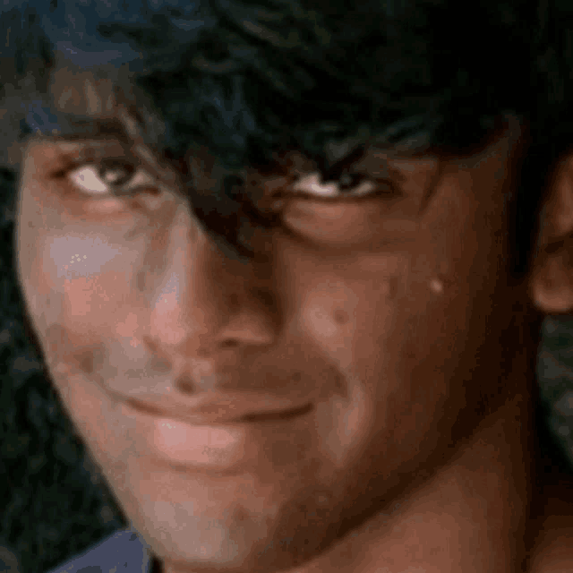 a close up of a man 's face with tears coming out of his eyes .