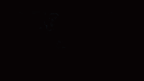 a woman is standing in the dark in a dark room looking at something .