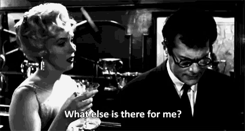 a black and white photo of a woman holding a martini and a man asking " what else is there for me "