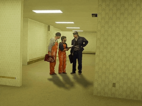 a group of people standing in a hallway with arrows on the wall