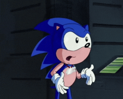sonic the hedgehog is giving a thumbs up sign in a dark room .
