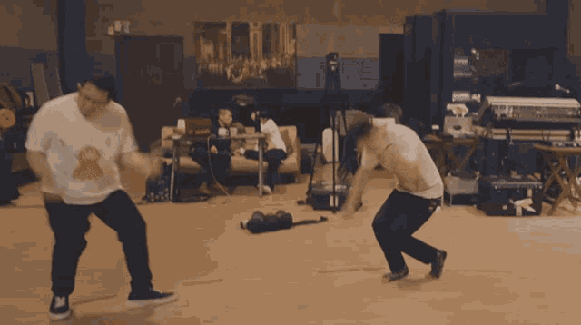 two men are dancing in a room with a sign that says ' exit '