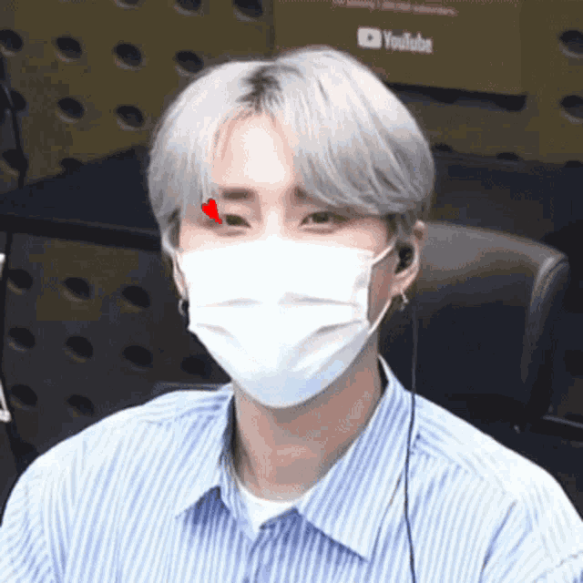 a man wearing a face mask with a red heart in his eye