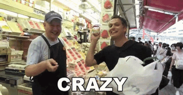 a man holding a bag in front of a sign that says crazy on it