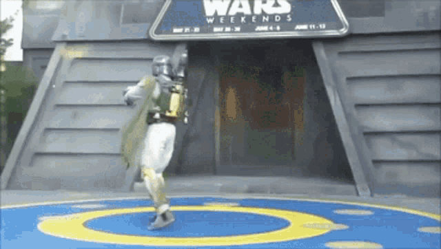 boba fett is dancing in front of a star wars weekends building