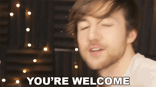 a man says " you 're welcome " in front of a blurry background
