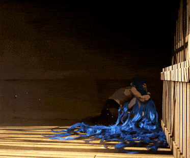 a woman with blue hair is hugging another woman