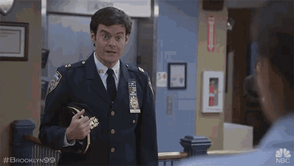 a man in a police uniform is making a funny face with the hashtag brooklyn99