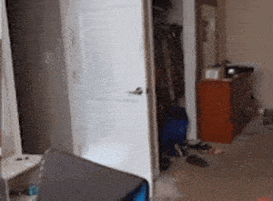 a bedroom with a dresser and a closet with clothes in it
