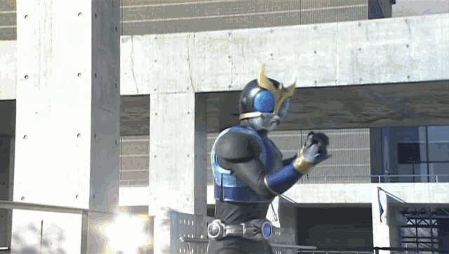 a person in a superhero costume is standing in front of a building