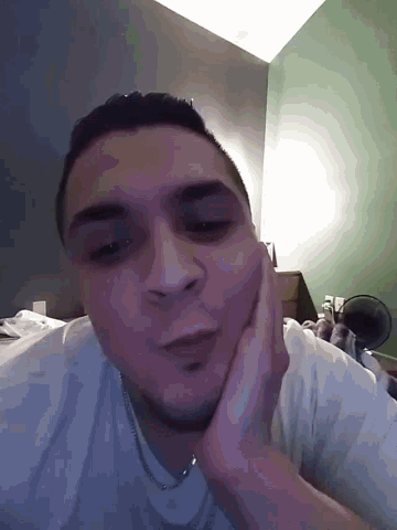 a man with a black eye rests his face on his hand