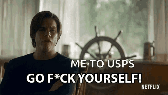 a man is sitting in front of a steering wheel and says go f * ck yourself