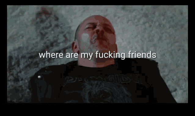 a man with blood on his face is laying on the ground with the words where are my fucking friends above him