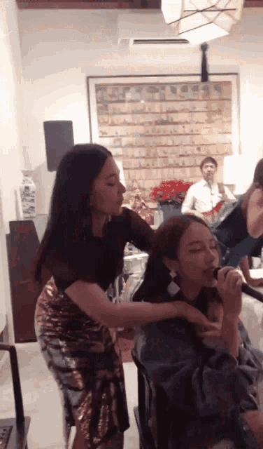 a woman in a sequined skirt is getting her hair done by another woman