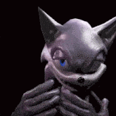 a cartoon cat with a blue eye is being held by a person .