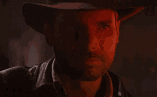 a man wearing a cowboy hat is saying `` trust me '' in a dark room .