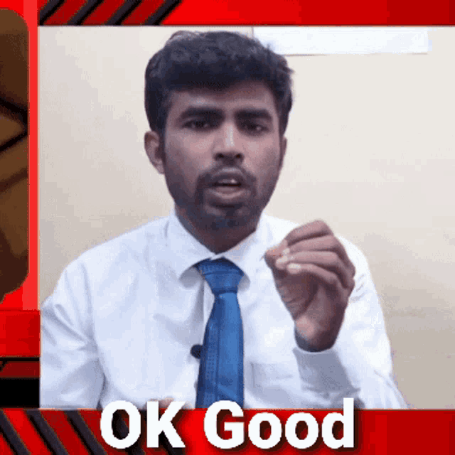 a man in a white shirt and blue tie is giving an ok good sign