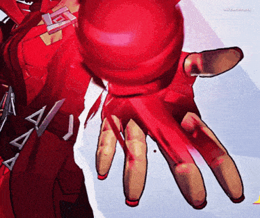 a close up of a person 's hand with a red ball in it and the words maxmofpops on the bottom right