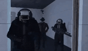 a group of men in suits and gas masks are walking down a hallway holding guns .