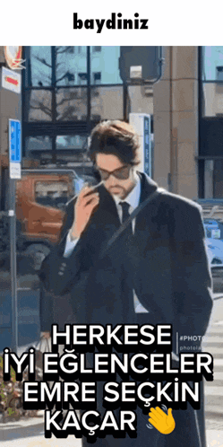 a man in a suit and tie talking on a phone