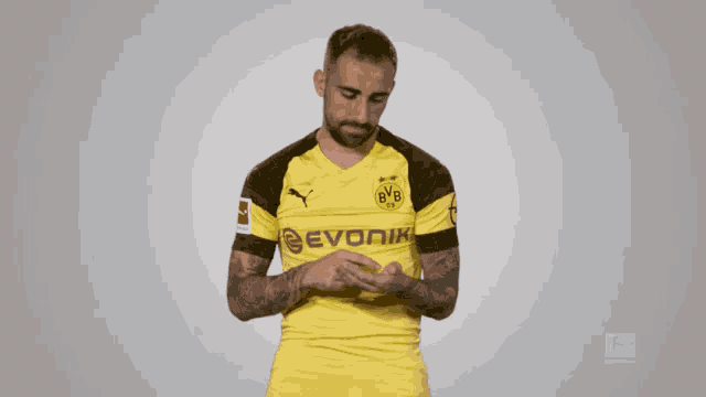 a man wearing a yellow jersey with bvb on the front