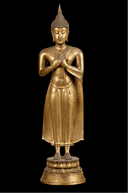 a gold statue of a buddha with his hands folded