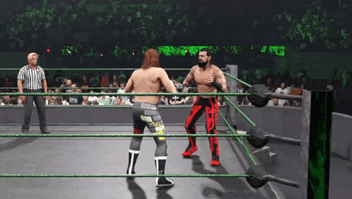 two men are wrestling in a ring with a referee in the background