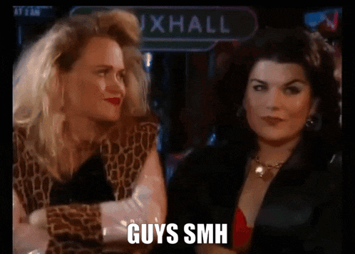two women are standing next to each other in front of a sign that says guys smh