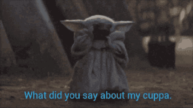 a baby yoda holding a cell phone with the words " what did you say about my cuppa " below him