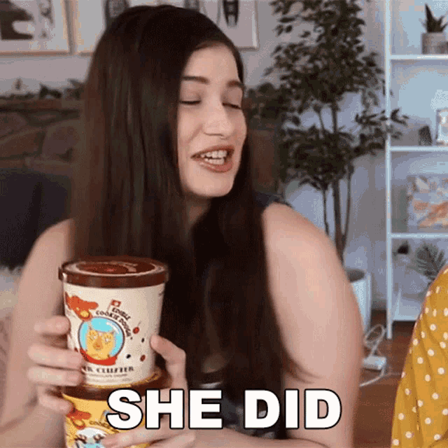 a woman is holding a container of ice cream with the words she did written on it