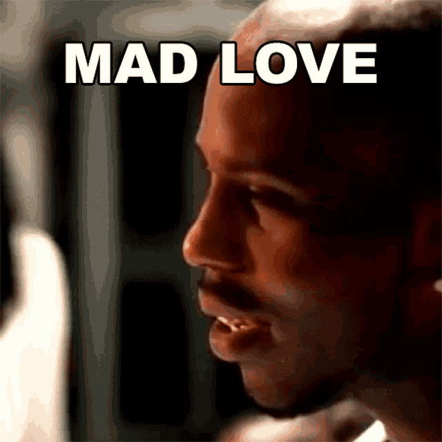 a close up of a man 's face with the words mad love in white letters