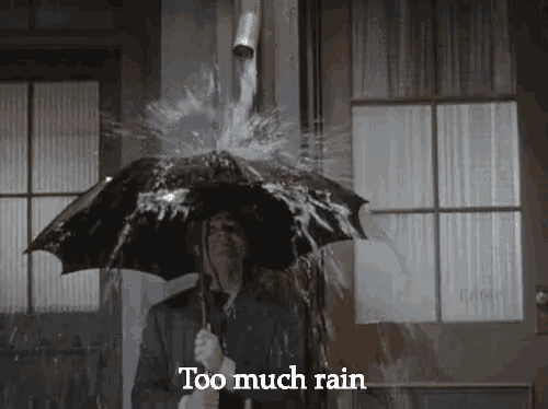 a man in a suit is holding an umbrella in the rain and water is coming out of a pipe .