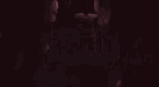 a group of people standing next to each other in a dark cave .