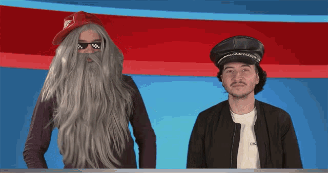 a man with a beard and a woman with a wig are standing next to each other in front of a red and blue background