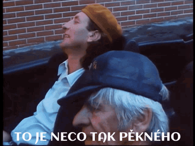 two men are sitting next to each other with the words to je neco tak pekneho on the bottom right