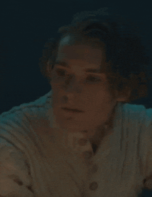 a close up of a man 's face in a dark room .