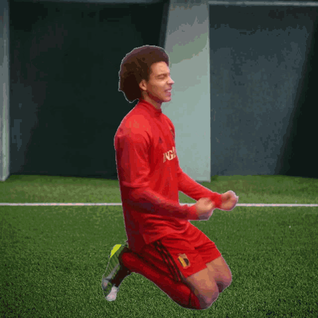a soccer player wearing a red shirt that says ig on it