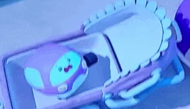 a cartoon character is laying in a crib with a blue light behind it .