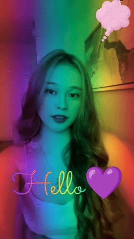 a girl with long hair says hello with a heart