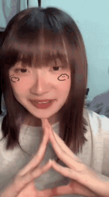 a girl with a cloud drawn on her face